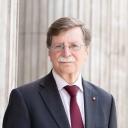 Profile picture of Paul Aplin OBE, a man wearing glasses and dressed in a suit.