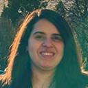 A headshot of Ghadeer Noufal smiling at the camera with long hair. 