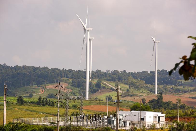 wind turbine farm on hill with power substation; credit: angkhan
