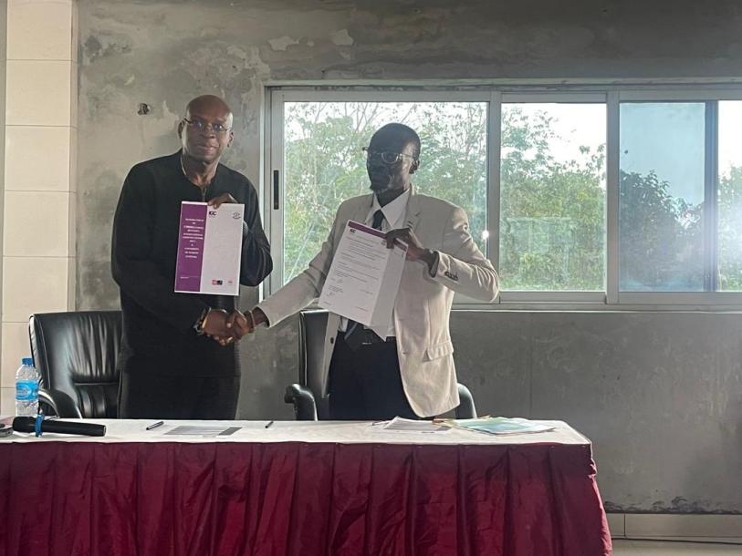 A photo of two researchers from Sierra Leonne shaking hands and launching the Landmark Local Research Fellowship