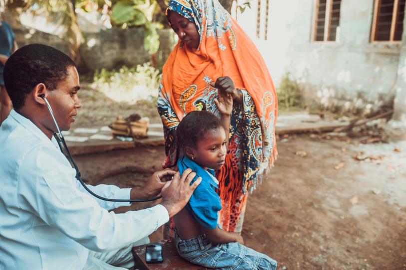 A doctor meets Tanzanian child - zeljkosantrac via getty images