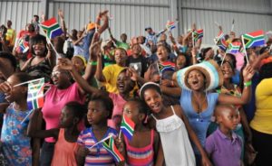 Photo: GCIS Members of the community waving flags at the Human Rights Day commemoration in Mbekweni, Paarl, in the Western Cape.